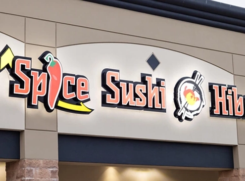Storefront sign reads "Thai Spice Sushi Hibachi Grill" with stylized graphics of a chili pepper and sushi roll above the entrance.